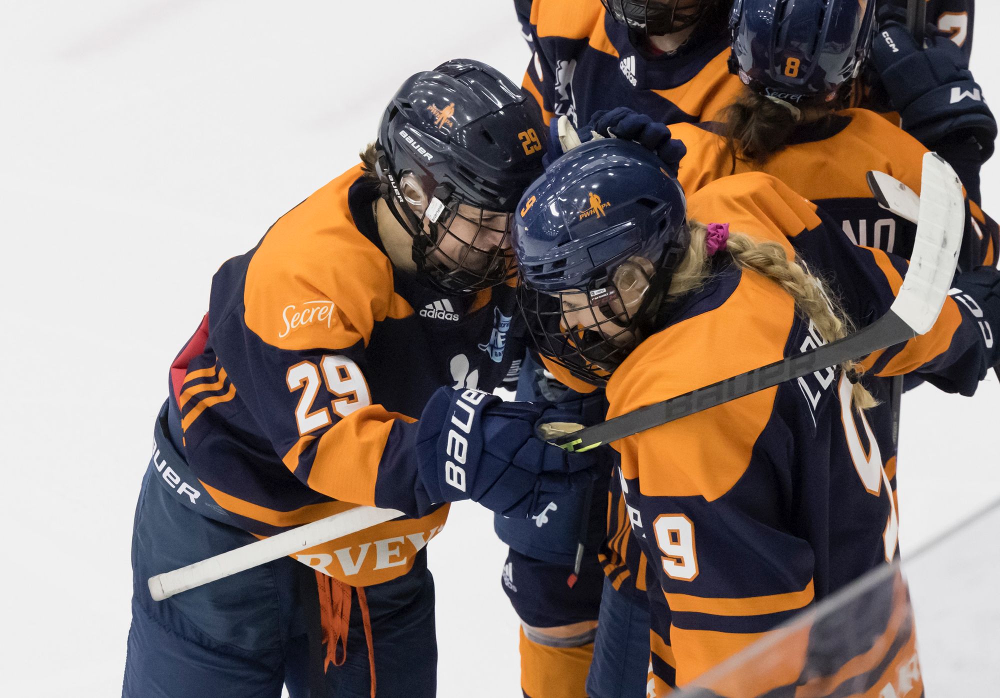 Marie-Philip Poulin celebrates with Jessie Eldridge on the ice for Team Harvey's of the PWHPA