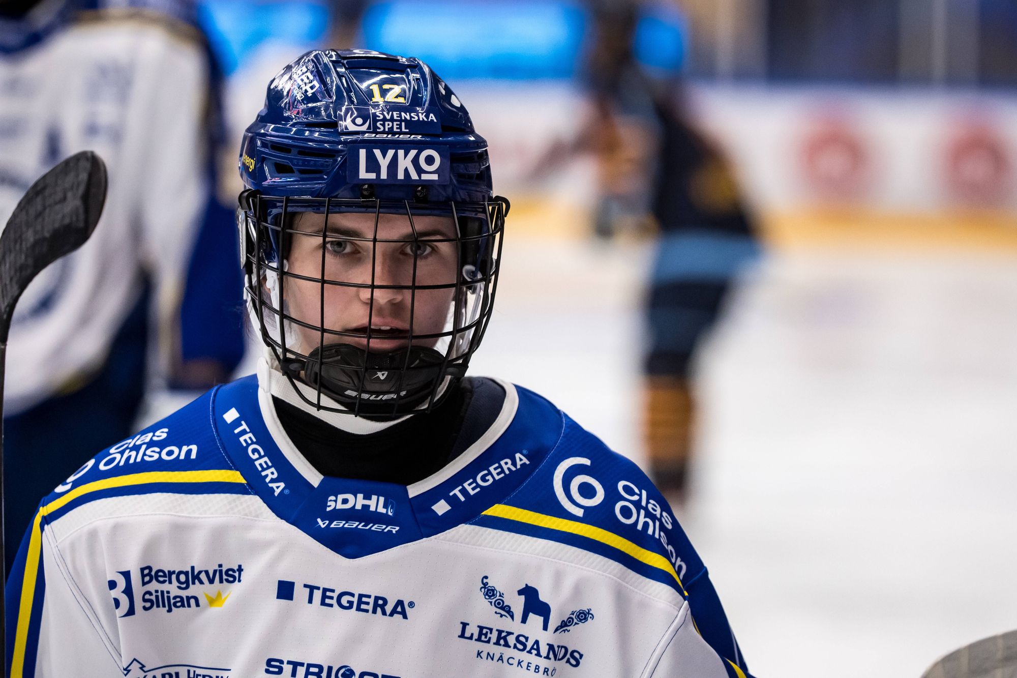 Autumn MacDougall in her SDHL Leksands IF uniform with helmet and face cage.